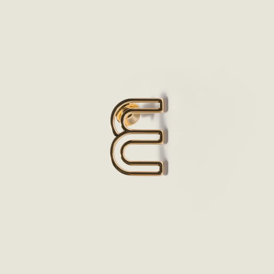 Metal logo brooch